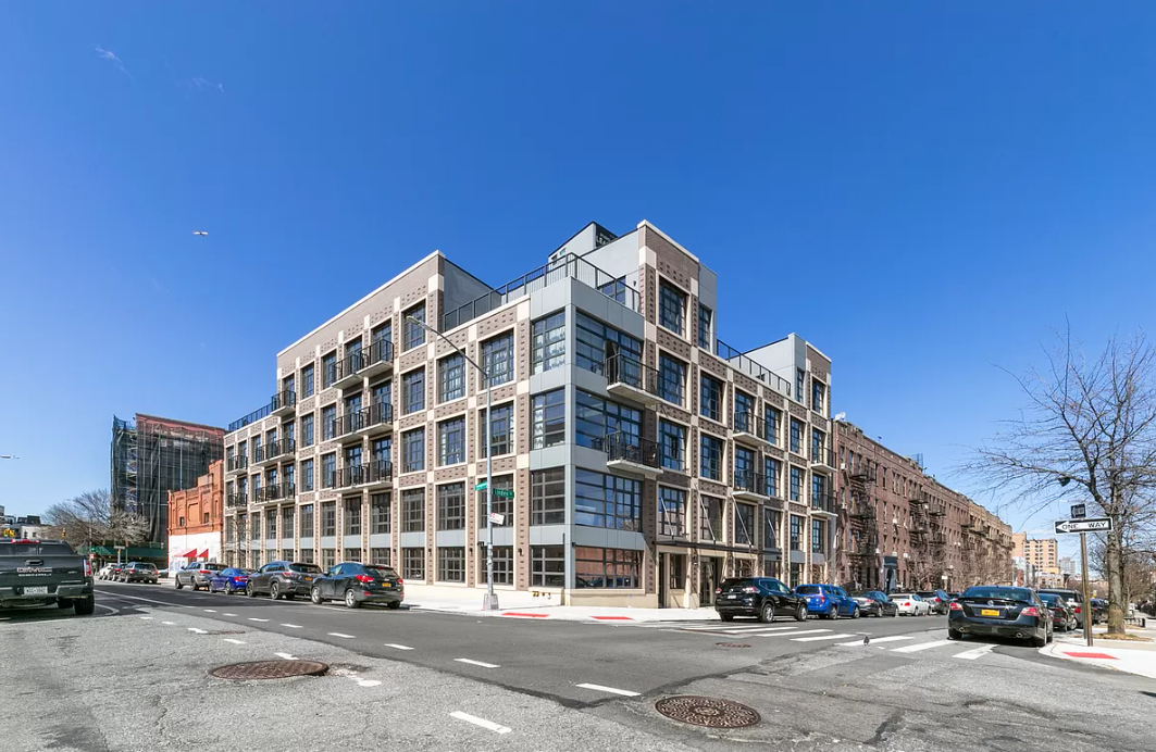 view from the street of an apartment building on a city street